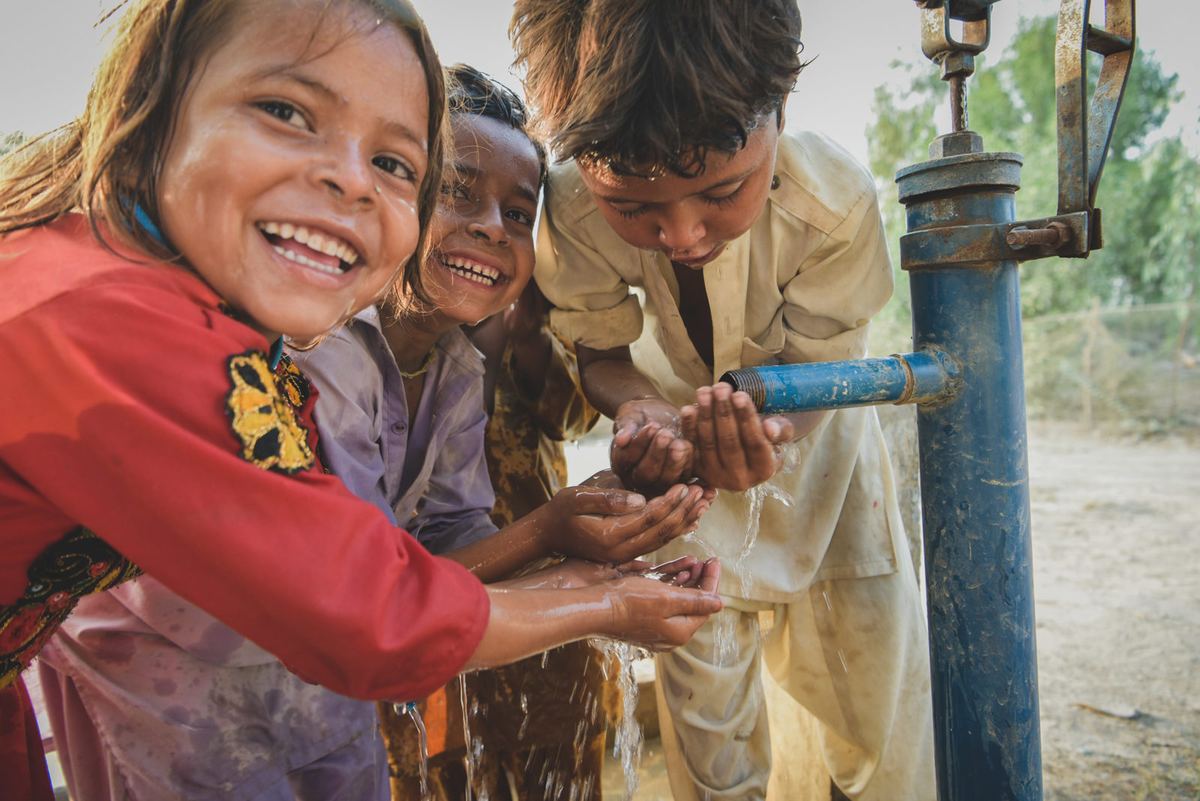 Children drink clean water from a tap